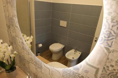 a small bathroom with a toilet and a sink at SUNSEA - Enjoy Your Family in Capo Vaticano