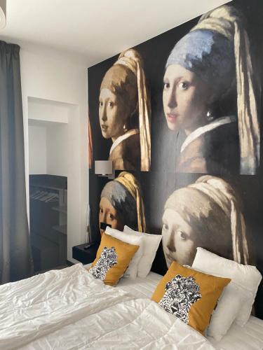 a bedroom with a large painting of two women at Villa Lavender in Felsőörs