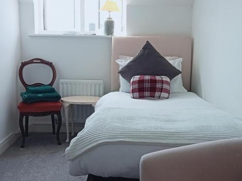 1 dormitorio con cama con almohada y silla en Little Paradise in Marlborough en Marlborough