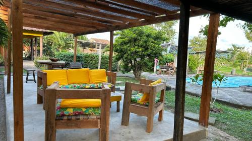 a patio with a table and chairs under a pergola at Hotel Urumajó in Augusto Correa