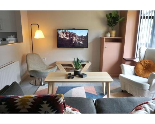 a living room with a couch and a table at Central Belfast Apartments The Village House in Belfast