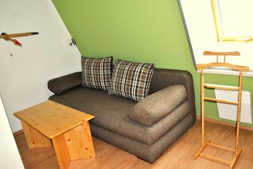 a living room with a couch and a table at Apartmán U Sjezdovky in Ostružná