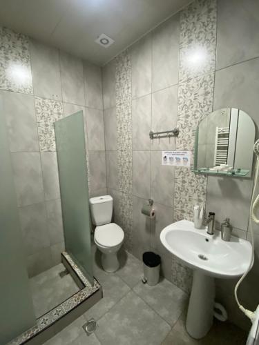 a bathroom with a toilet and a sink at Hotel Elegant in Stepantsminda