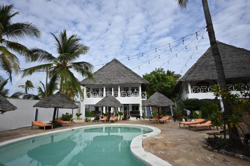 a villa with a swimming pool and a resort at Ananda Villa Zanzibar in Bwejuu