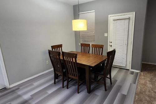 a dining room with a wooden table and chairs at Sunny apartments in Bayburt