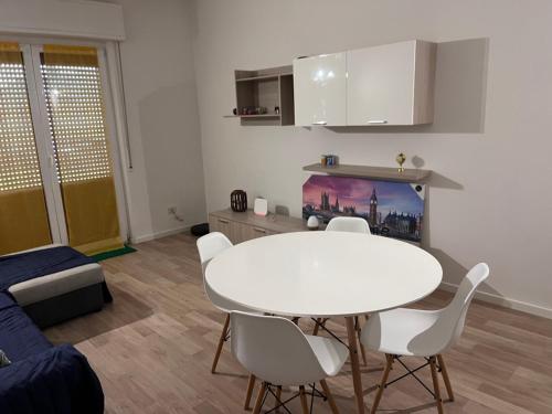 a living room with a white table and chairs at Smart Holiday in Capriate San Gervasio