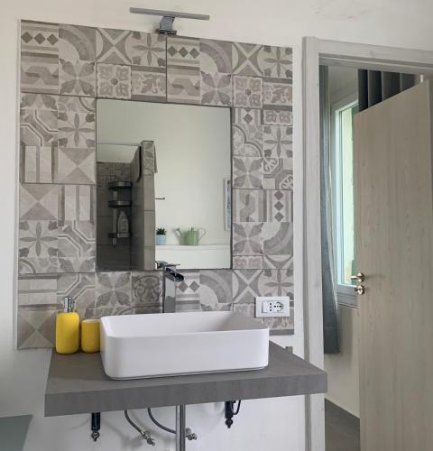a bathroom with a white sink and a mirror at Ca' Salino in Villa Inferno
