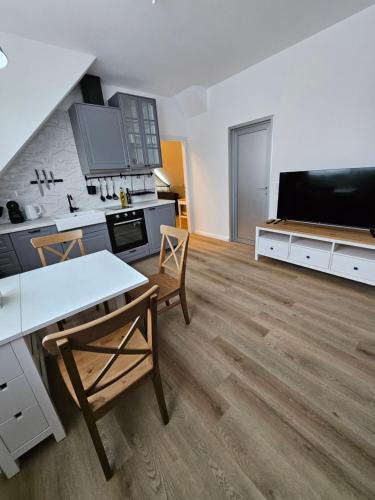 a kitchen with a table and chairs in a room at Best Prater Apartments in Vienna