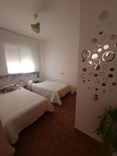 a room with two beds and a wall with planets at Chalet Edy con piscina in Peniscola