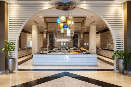 a restaurant with a buffet in the middle of a building at Cleopatra Luxury Resort Sharm - Adults Only 16 years plus in Sharm El Sheikh