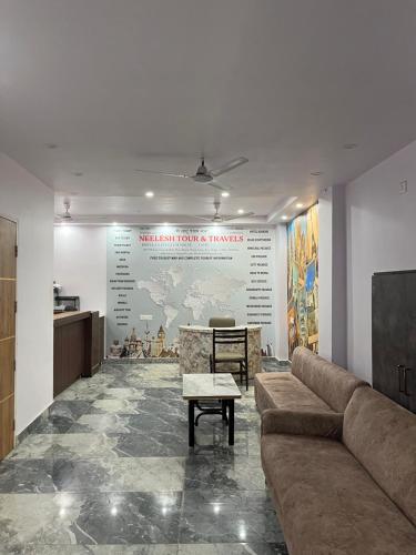 a lobby with a couch and a map of the world at S B Guest House Near New Delhi Train Station in New Delhi