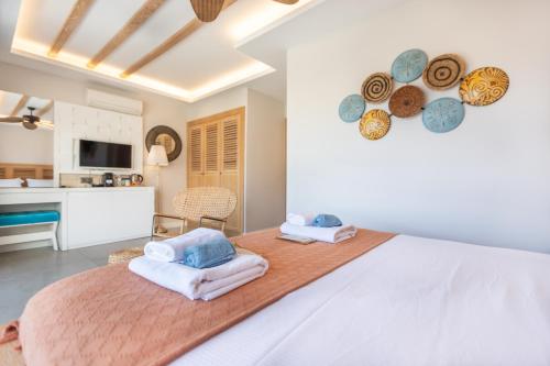 a bedroom with a large bed with towels on it at Kalkan Saray Suites Hotel in Kalkan