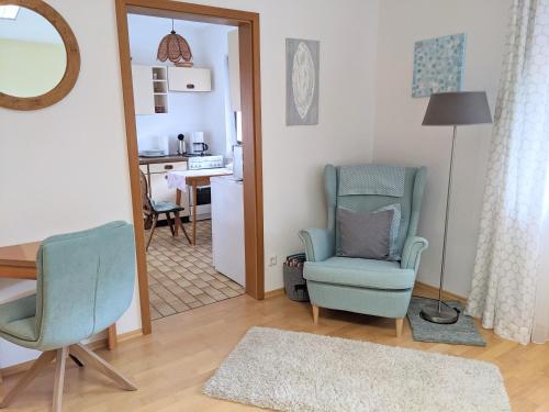 a living room with two chairs and a table at Ferienwohnung Fischer in Unterreichenbach