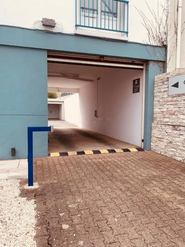 an empty parking garage with a blue building at Hôtel Escale Oceania Lorient in Lorient