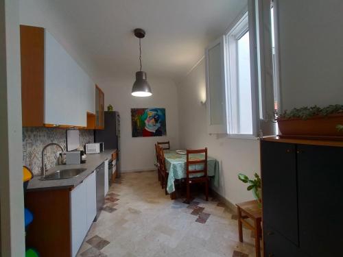 a kitchen with a sink and a table in it at Loggia58 in Trapani