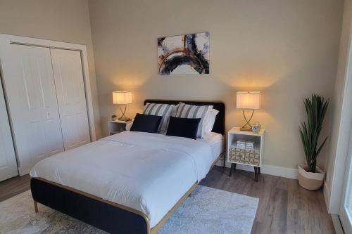 a bedroom with a large bed with two lamps at Fully Furnished Alluring Turn Key Luxury Oasis in Wellington