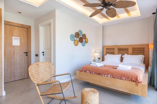 a bedroom with a bed and a ceiling fan at Kalkan Saray Suites Hotel in Kalkan