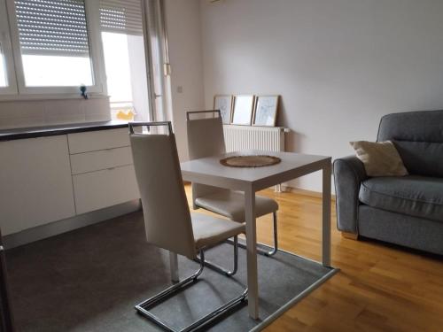 a small table and chairs in a living room at Apartment City in Zagreb