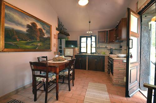 a kitchen with a table and chairs in a room at La Casina di Sarteano in Sarteano