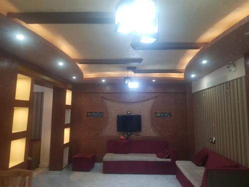 a room with a tv on the ceiling and a couch at شارع اسكندرية in Marsa Matruh