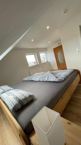 a bedroom with a large bed in a attic at Casa Grande mit 3 Apartments in Rastatt