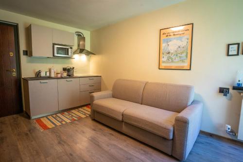 sala de estar con sofá y cocina en Morgex Mont Blanc - Petite Maison - CIR Morgex 16, en Morgex