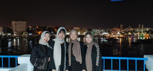 a group of women posing for a picture at night at La Terrace in Aswan