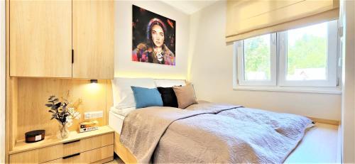 Cama o camas de una habitación en VIP APARTAMENTY Chałubińskiego APART
