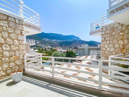 a balcony of a house with a white fence at Kalkan Saray Suites Hotel in Kalkan
