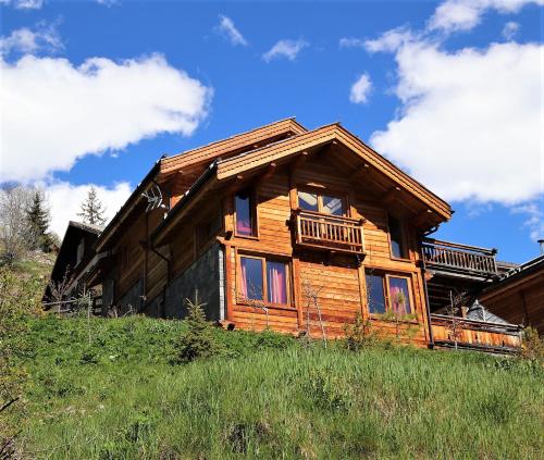 a log cabin on top of a hill at Prestigious 18 Person Chalet with Pool and Jacuzzi in Vars