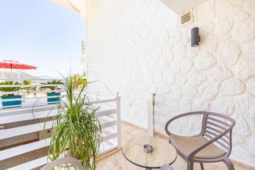 a chair and a table on a balcony at Kalkan Saray Suites Hotel in Kalkan