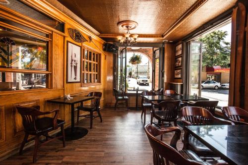 a restaurant with wooden walls and tables and chairs at Regent Hotel Revelstoke in Revelstoke