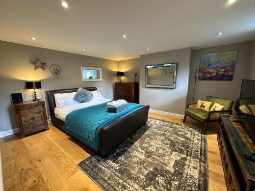 a bedroom with a bed and a living room at The School House, Sowood, Halifax in Halifax
