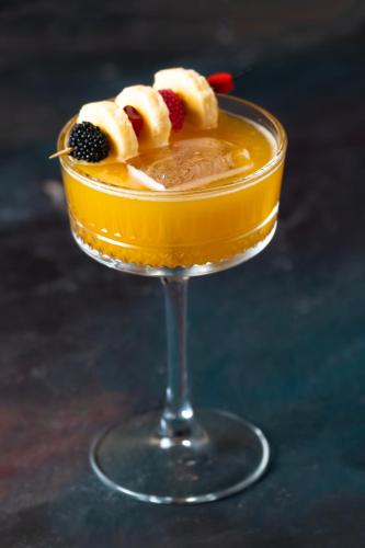 a drink in a glass with fruit on top at Kalkan Saray Suites Hotel in Kalkan