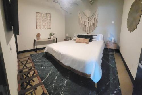 a bedroom with a large white bed in a room at Silo View - heart of downtown in Waco