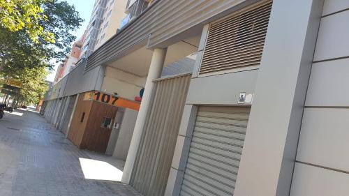 a building with two garage doors on a street at apartment in Valencia