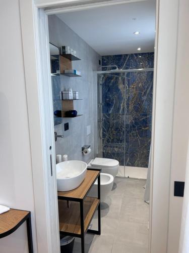 a bathroom with a toilet and a sink and a shower at Hotel Arya by Mauro in Sirmione