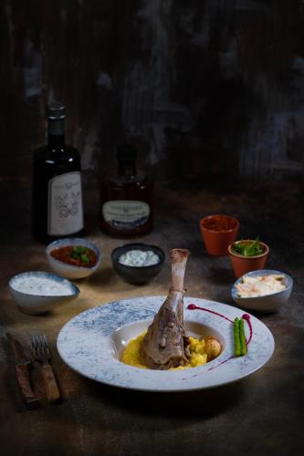 a plate of food on a table with bottles of wine at Kalkan Saray Suites Hotel in Kalkan