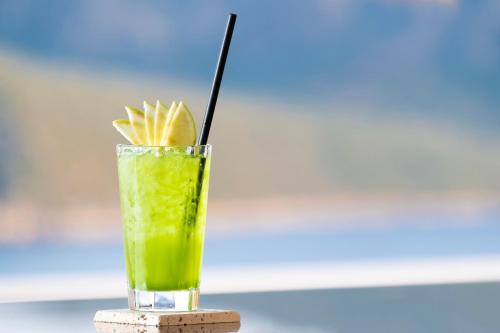 a drink in a glass sitting on a coaster at Kalkan Saray Suites Hotel in Kalkan