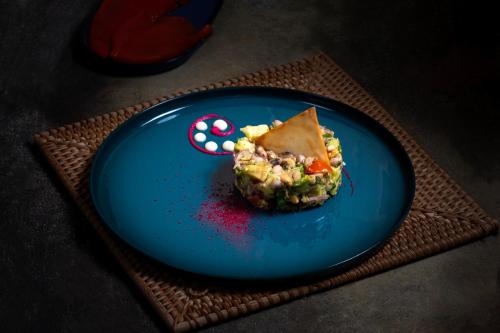 a blue plate with a piece of food on it at Kalkan Saray Suites Hotel in Kalkan