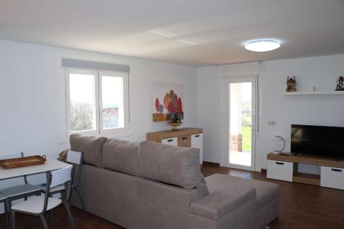 a living room with a couch and a table at “Casa abella “ in La Magdalena