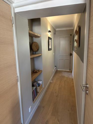 a hallway with a book shelf in a house at CABADOL - Appartement Aix centre historique - très calme - 50m cours Mirabeau in Aix-en-Provence