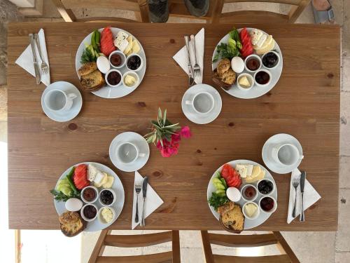a wooden table with plates of food on it at AGON Ephesus in Selcuk
