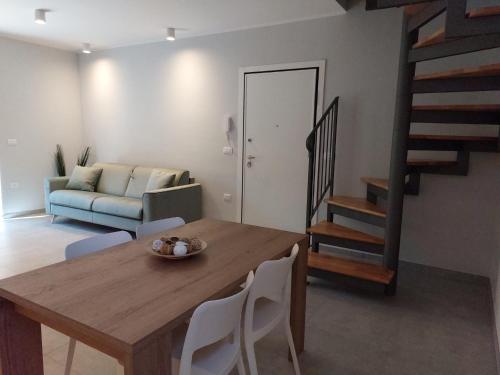 a living room with a wooden table and chairs at Casetta San Marciano Pile in LʼAquila