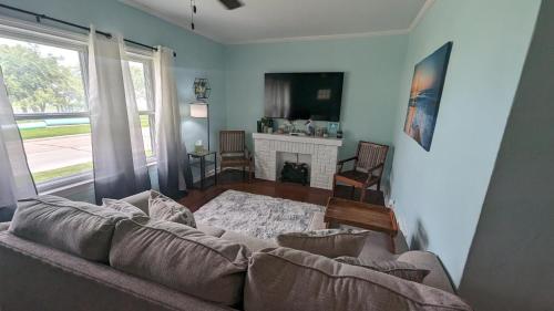 a living room with a couch and a fireplace at Cozy 2 bedroom home w/Lake View in Lorain
