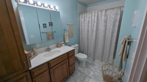 a bathroom with a sink and a toilet and a mirror at Cozy 2 bedroom home w/Lake View in Lorain