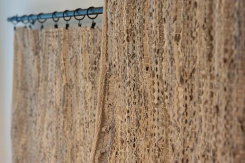 a shower curtain hanging from a shower rod at Corte Giorgi in Breno