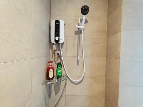 a shower in a bathroom with a phone on a wall at Armadale Galacity Minimalist 3 Bedrooms Entire Apartment in Kuching