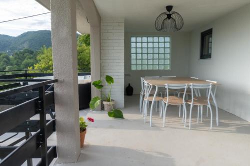 a kitchen with a table and chairs on a balcony at Deja View in Ivančići