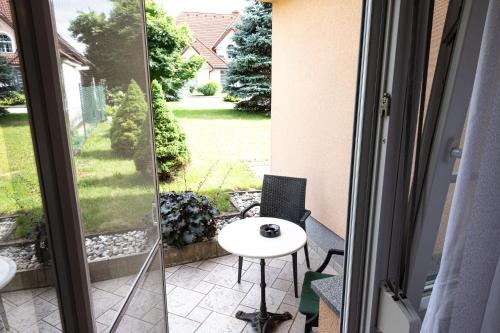 a balcony with a table and a view of a yard at Apartmaji in sobe RaMar in Straža
